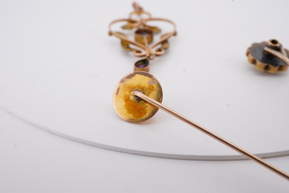 An Edwardian 15ct, diamond and seed pearl cluster set stick pin, 54mm, a similar yellow metal and cabochon garnet set stick pin and an Edwardian 9ct and gem set drop pendant. Condition - poor to fair